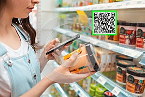 Shopping. Young woman scans qrcode of the body cream. Modern technology in everyday life. Close up