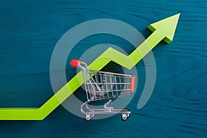 Shoppingcart green up arrow, sales and revenue growth concept