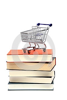 Shoppingcart on top of books photo