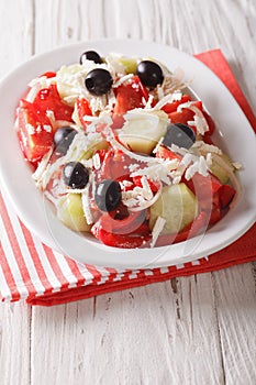 Shopska salad from fresh vegetables with feta cheese close-up. v