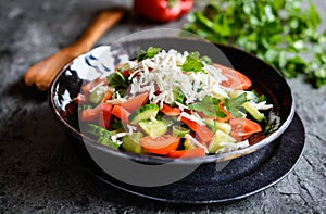 Shopska Salad - Bulgarian salad with tomato, cucumber, pepper, scallion, parsley and cheese