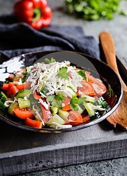 Shopska Salad - Bulgarian salad with tomato, cucumber, pepper, scallion, parsley and cheese