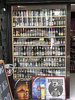 A shopwindow of a beer shop full of different brands of beer