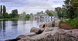 Shore with big stones at Schwerin lake overlooking the Restaurante rowing club. Germany photo