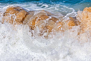 Shore breaking wave on sand beach