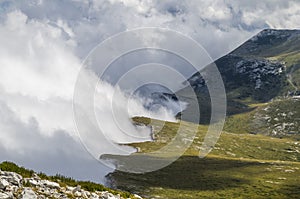 Shore with clouds in the mountain