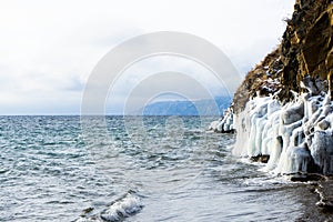 The shore is covered with ice during a storm on Lake Baikal.