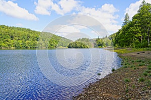 On the shore of Derwent Reservoir with a partially hidden Howden Dam in the distance