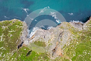 Shore with geological caves made by waves by jesters bufones of arenillas, Spain near city Llanes in August 2023