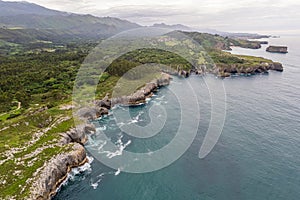 Shore with geological caves made by waves by jesters bufones of arenillas, Spain near city Llanes in August 2023