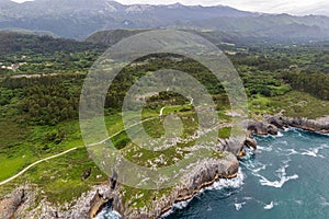 Shore with geological caves made by waves by jesters bufones of arenillas, Spain near city Llanes in August 2023