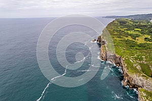 Shore with geological caves made by waves by jesters bufones of arenillas, Spain near city Llanes in August 2023