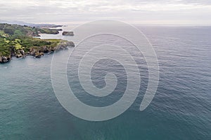 Shore with geological caves made by waves by jesters bufones of arenillas, Spain near city Llanes in August 2023