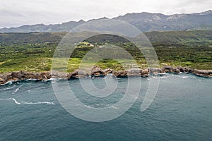 Shore with geological caves made by waves by jesters bufones of arenillas, Spain near city Llanes in August 2023