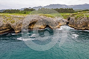 Shore with geological caves made by waves by jesters bufones of arenillas, Spain near city Llanes in August 2023