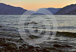 Shore of lake Teletskoye at sunset