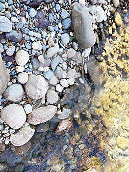 The shore of a mountain river with stones