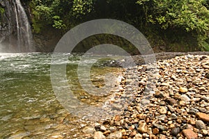 Shore of the pool below the waterfall on the Hollin River in Ecuador photo