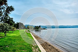 A shore and water`s edge of Nicaea iznik lake during sunny day photo