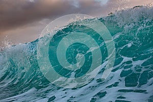 Shorebreak wave at sunset time