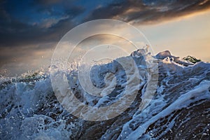 Shorebreak wave at sunset time