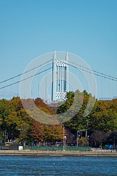 Shoreline of Astoria Queens New York with Colorful Autumn Trees and a Bridge in the Background