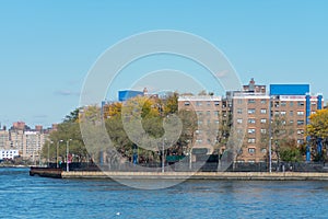 Shoreline of Astoria Queens New York with Public Housing Buildings and the East River with Colorful Autumn Trees
