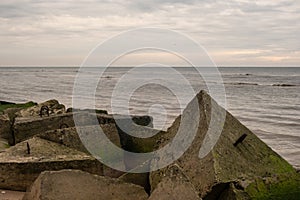 Shoreline Geometry: Seafront Stacks of Concrete Blocks, Where Manmade Forms Meet the Endless Sea