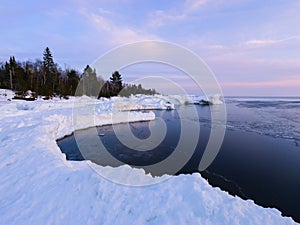 Shoreline of Lake Superior in winter at sunset