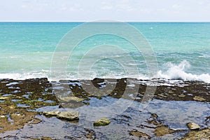 Shoreline with rocks and small waves photo