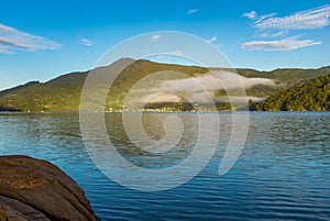 A shoreline view of the beautiful and stunning Marlborough Sound and the surrounding hills at the top of the South Island