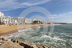 Shoreline view of Quarteira beach photo