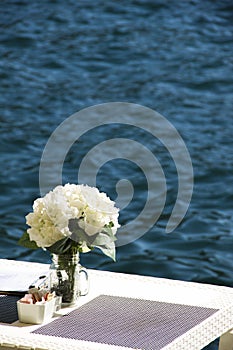 Shoreside table setting with blurred sea