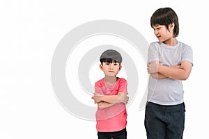 Short child boy in red t shirt and tall child boy in white t shirt standing arms crossed and looking face isolated on white