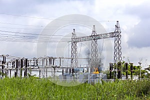 Short circuit at the transformer at high voltage substation and a lot of fire or flames and smoke occurred photo