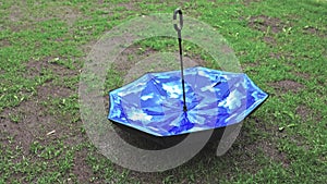 Short film showing rain weather and umbrella on green lawn. Rainy season concept.