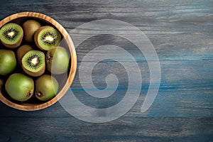 Short food supply chains SFSCs.From garden to plate concept.A bowl of fresh kiwis on the wood table.Flat lay,Copy space