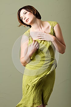 Short hair brunette woman with green dress