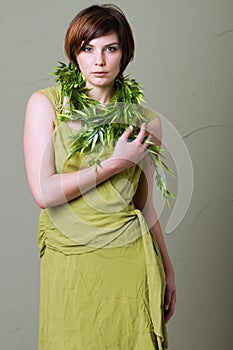 Short hair brunette woman with green dress