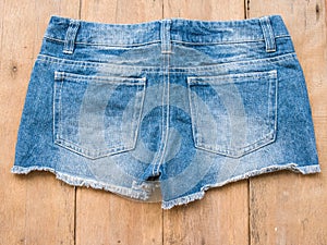 Short jean on wood background