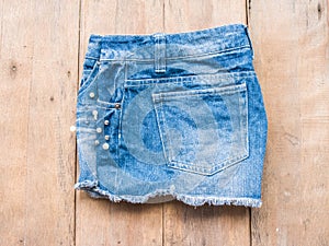 Short jean on wood background