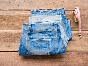 Short jeans with belt on wood background