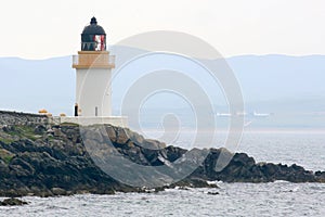 Small white lighthouse on Scottish island photo