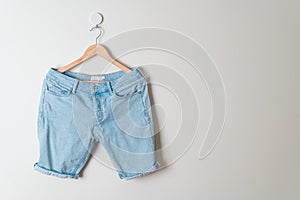 Short pants jeans hanging on hanger