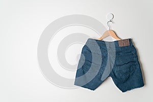 Short pants jeans hanging on hanger