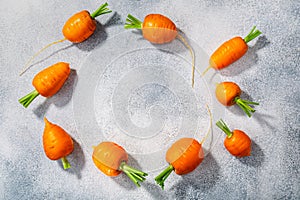 Short Rondo carrots on grey textured background with copy space,  top view