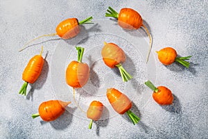 Short Rondo carrots on grey textured background,  top view
