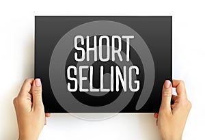 Short Selling - sale of a stock you do not own, text concept on card