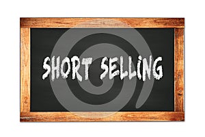 SHORT  SELLING text written on wooden frame school blackboard