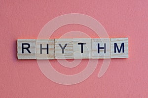 Short small lettering rhythm in gray wooden letters with black fon photo